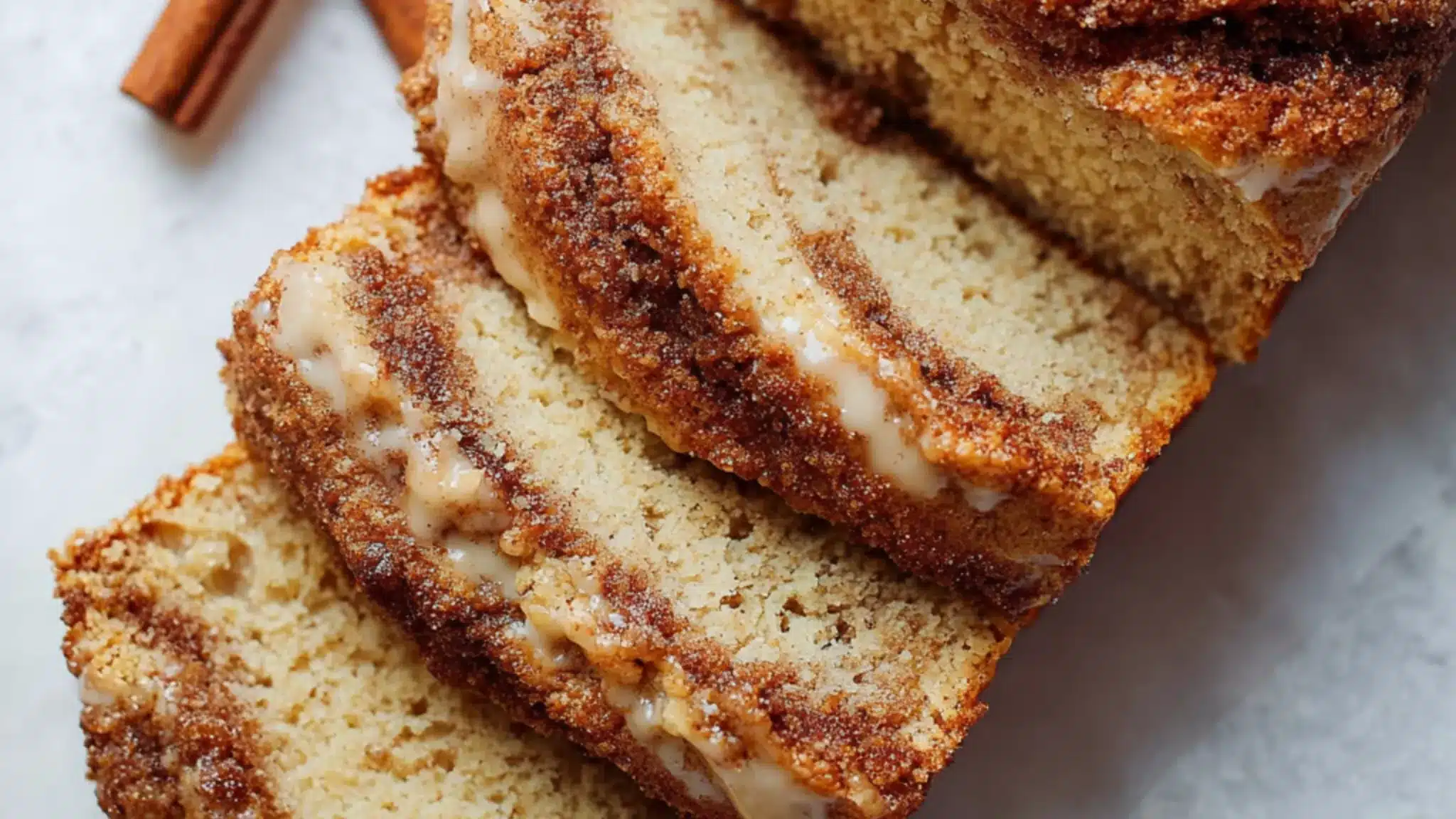 Keto cinnamon loaf bread sliced with soft crumb and creamy cinnamon filling