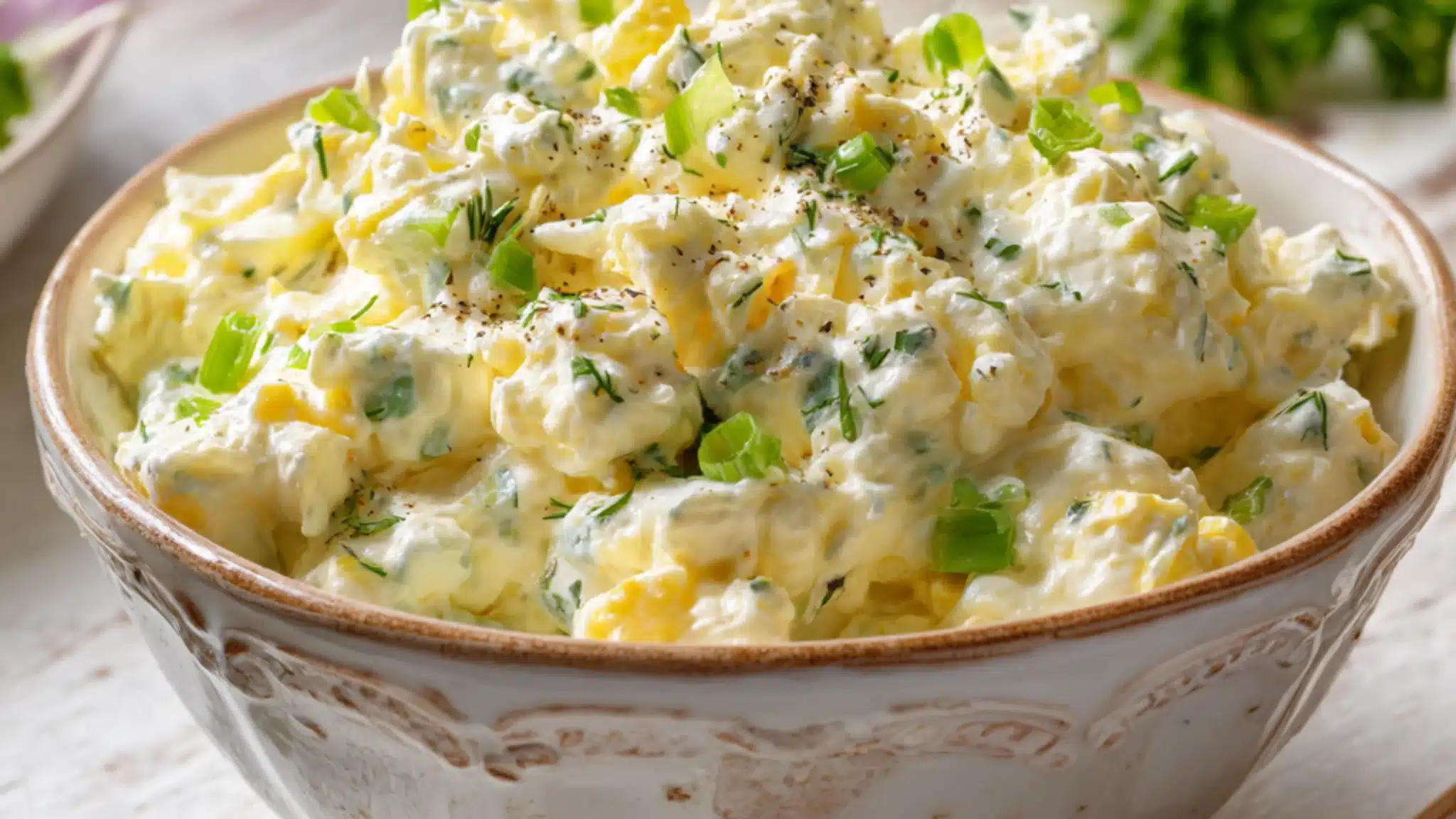 creamy egg salad with cottage cheese green onions and herbs in a bowl